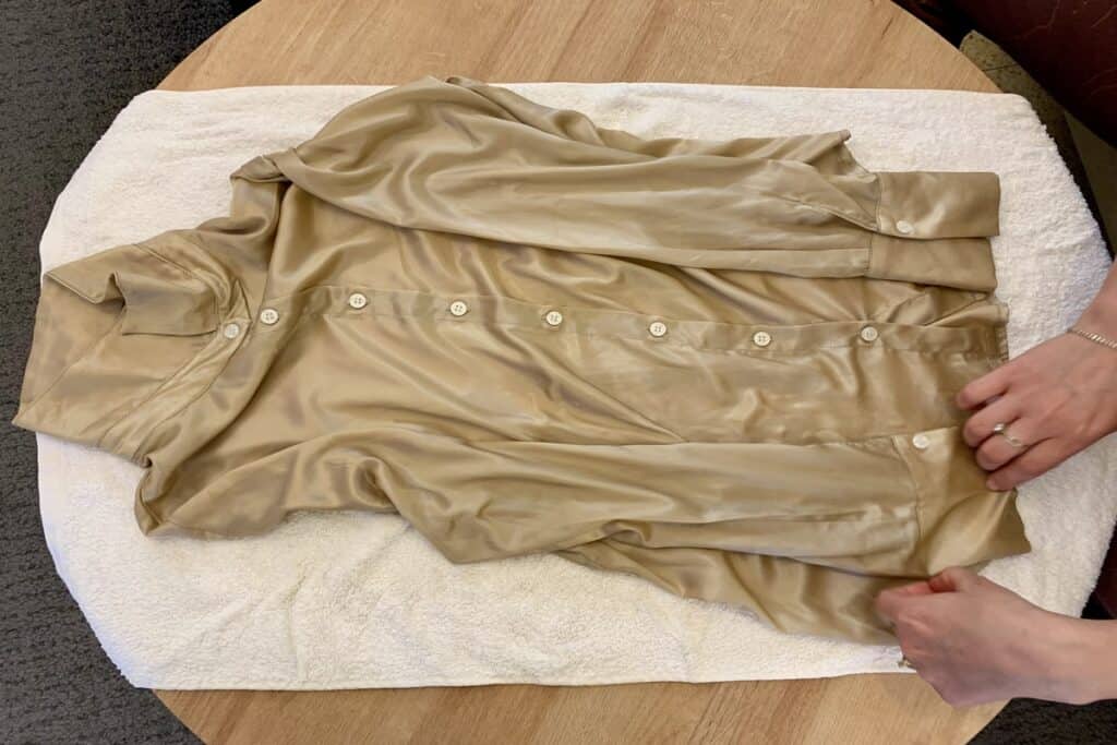 towel drying beige silk shirt gently