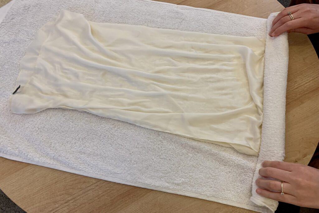 towel press drying white silk scarf